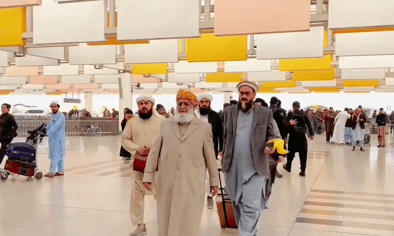 The photo shows Maulana Fazlur Rahman, the leader of Pakistan's Jamiat Ulema-e-Islam party, at an airport with a few associates.