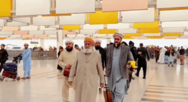 The photo shows Maulana Fazlur Rahman, the leader of Pakistan's Jamiat Ulema-e-Islam party, at an airport with a few associates.