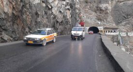 The photo shows a small vehicle traveling on the dangerous mountain road from Kabul to Jalalabad near the Mahipar area.