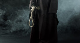 partial view of woman in death costume holding hanging noose in smoke on black