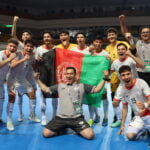 Afghanistan Futsal Team after defeating Kyrgyzstan in a World Cup qualifier match. The Afghan national flag is visible.