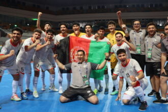 Afghanistan Futsal Team after defeating Kyrgyzstan in a World Cup qualifier match. The Afghan national flag is visible.