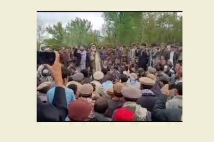 Photo of community leaders speaking at a public gathering during protests in Badakhshan, with people gathered around them. The image is a screenshot from a video shared on social media