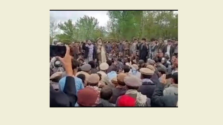 Photo of community leaders speaking at a public gathering during protests in Badakhshan, with people gathered around them. The image is a screenshot from a video shared on social media