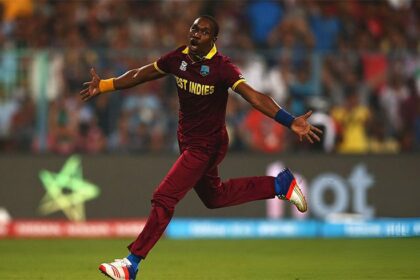 Dwayne Bravo, wearing the West Indies cricket team uniform, celebrates energetically during a match. He has his arms outstretched and a look of triumph on his face. Image Credit: Afghanistan Cricket Board Website